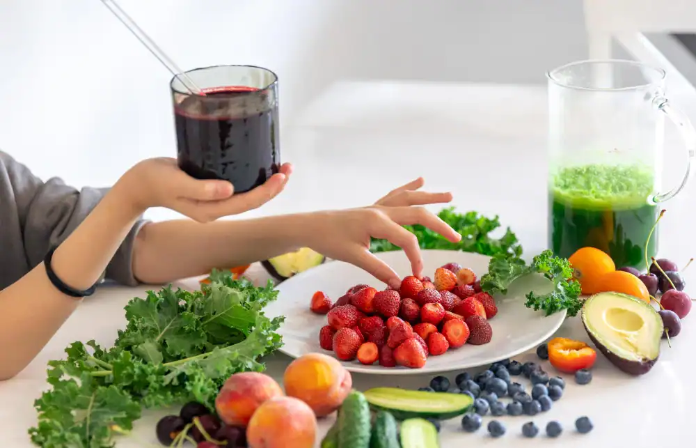 Sibo Support at In Good Nutrition, A person holds a glass of dark juice on a white table.
