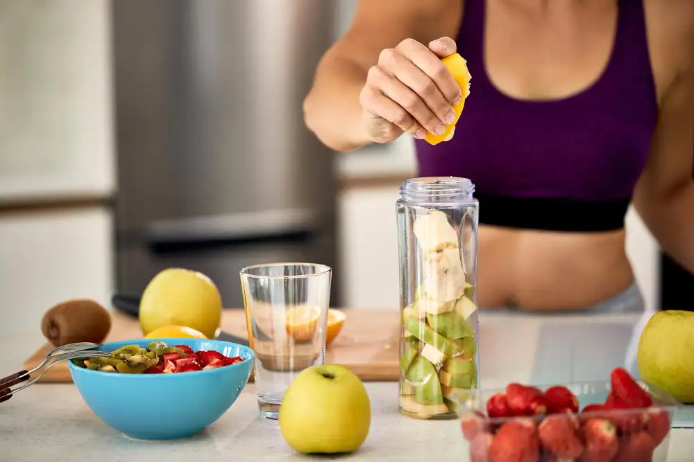 Sports Nutrition Deititian Nutritionist, Woman in sports clothes making home made fruit juice