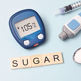 Diabetes sugar reader and the word SUGAR spelt out in letters