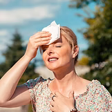 Woman wearing a t-shirt experiencing a hot flash